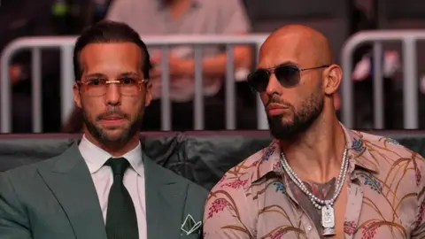Reuters Andrew Tate and Tristan Tate are pictured sitting together at a UFC match.