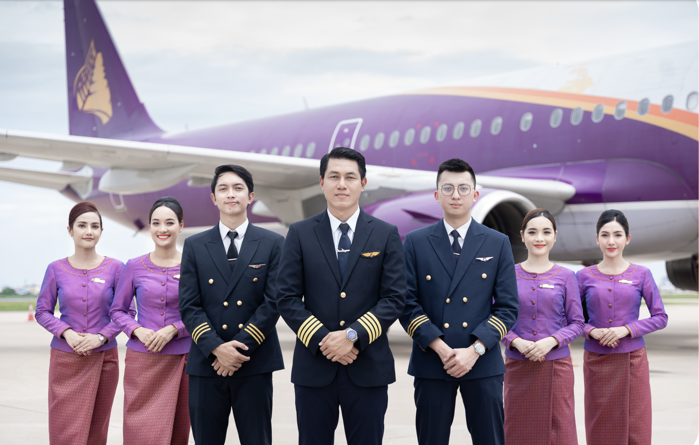 Air Cambodia crew in uniforms and aircraft with brand livery.