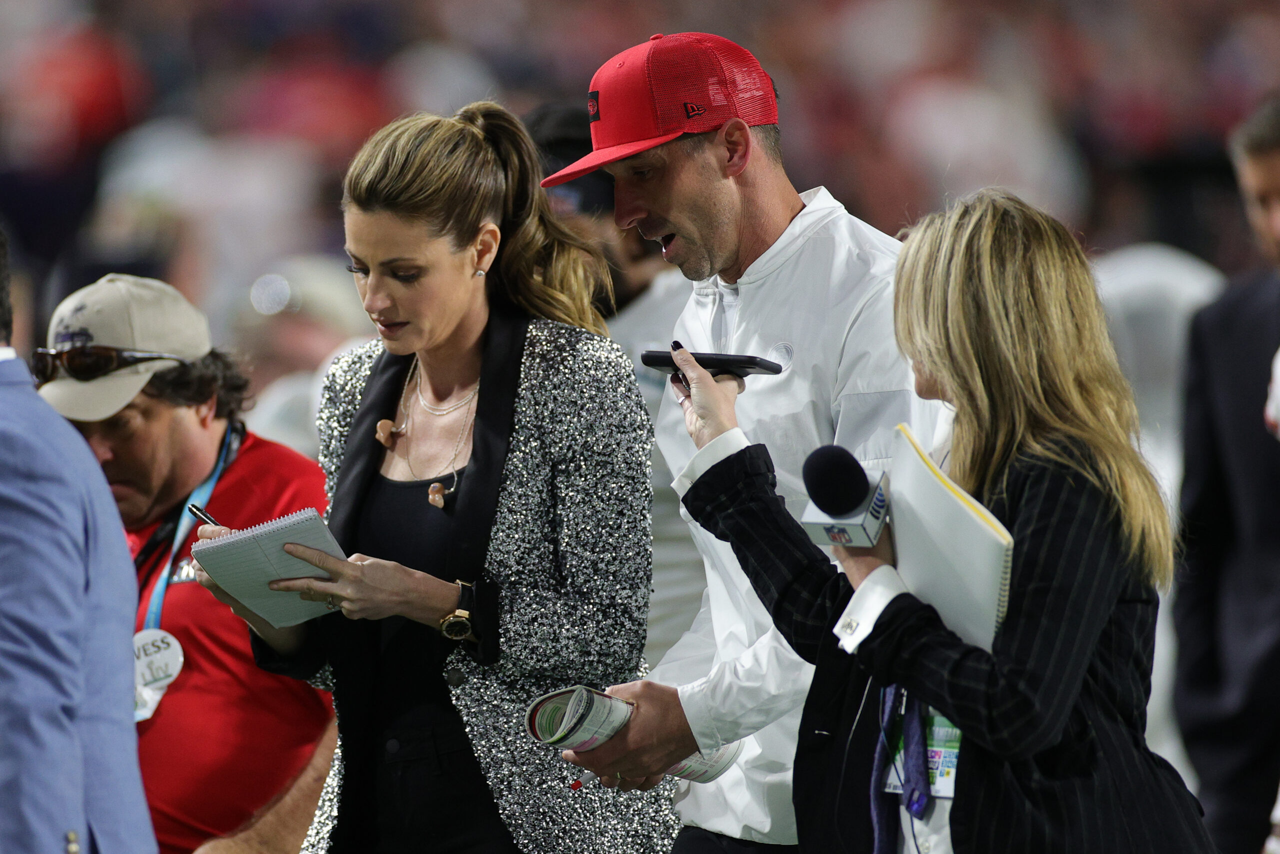 Head coach Kyle Shanahan of the San Francisco 49ers talks with Fox Sports reporter Erin Andrews as he walks off the field at halftime in Super Bowl LIV against the Kansas City Chiefs at Hard Rock Stadium on February 02, 2020 in Miami, Florida.