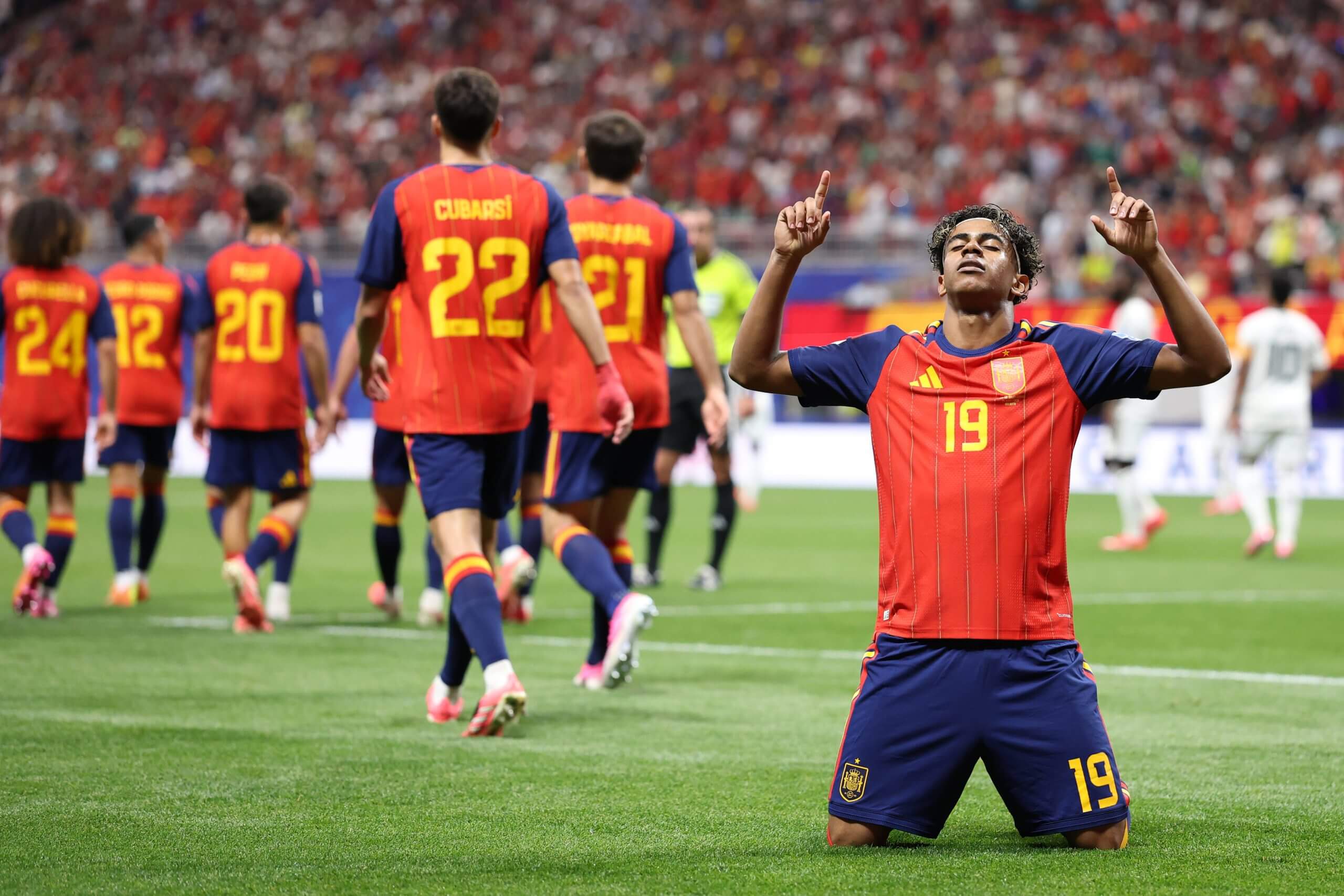 Lamine Yamal kneels and points to the sky as he celebrates his goal against Saudi Arabia