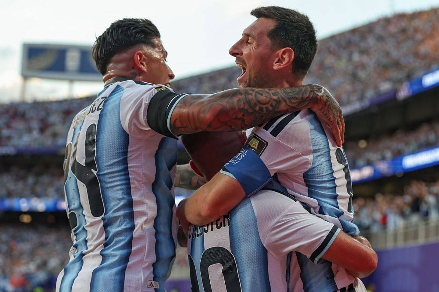 KANSAS CITY, MO - JULY 11: Lionel Messi #10, Enzo Fernandez #24 and Alexis Mac Allister #20 of Argentina hug to celebrate Mac Alister's goal in the first half of the FIFA World Cup 2026 Quarterfinal match between Argentina and Switzerland on July 11, 2026 at Kansas City Stadium in Kansas City, MO. (Photo by Scott Winters/Icon Sportswire via Getty Images)