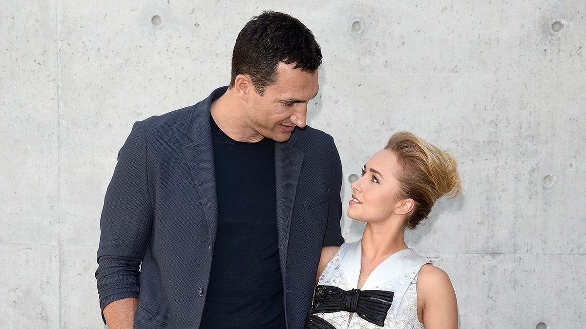Wladimir Klitschko and Hayden Panettiere attend a fashion show seated together in Milan.