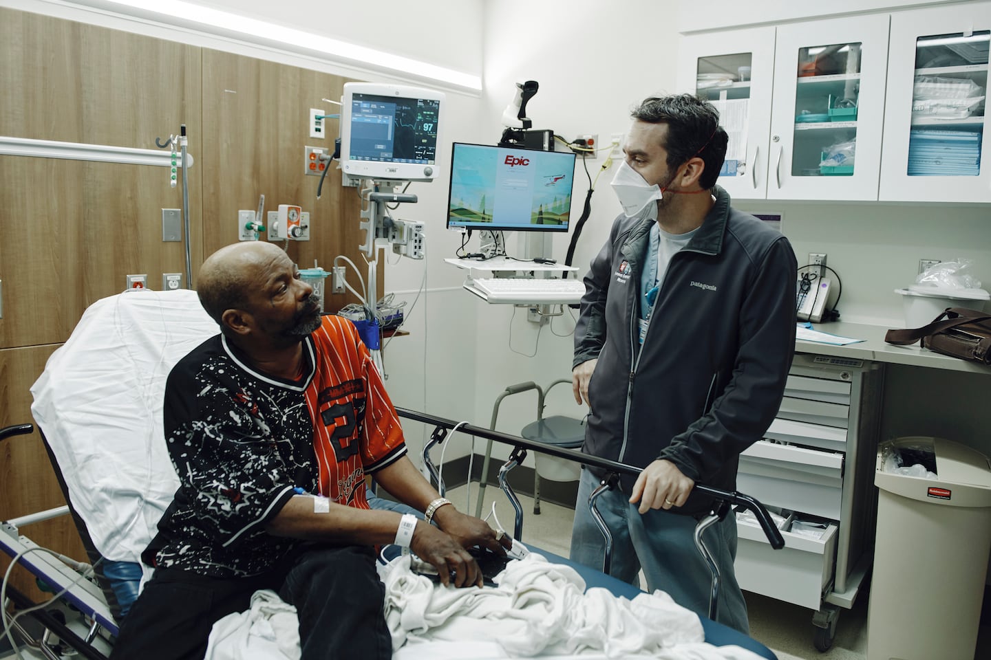 Faust with Brian Johnson, a patient who came in with shortness of breath, at Brigham and Women’s Hospital in May.
