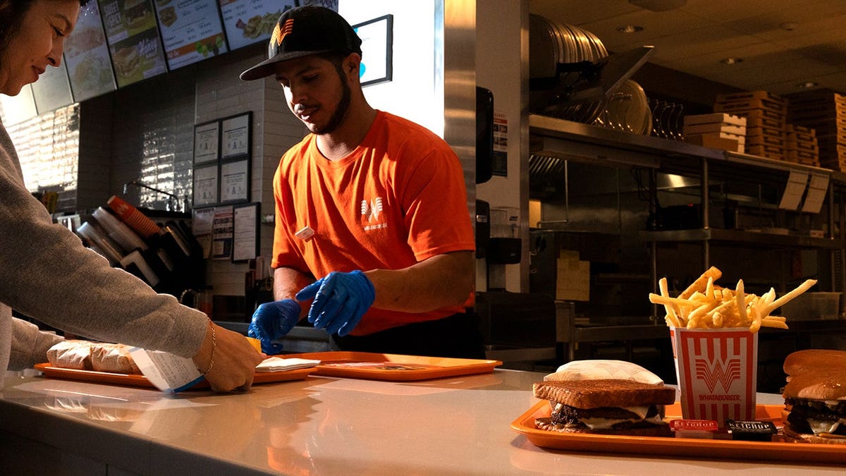 Whataburger employee assisting customer