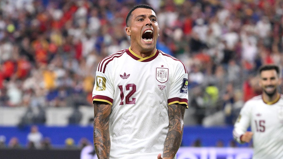 Pedro Porro celebrates after scoring for Spain on the field.
