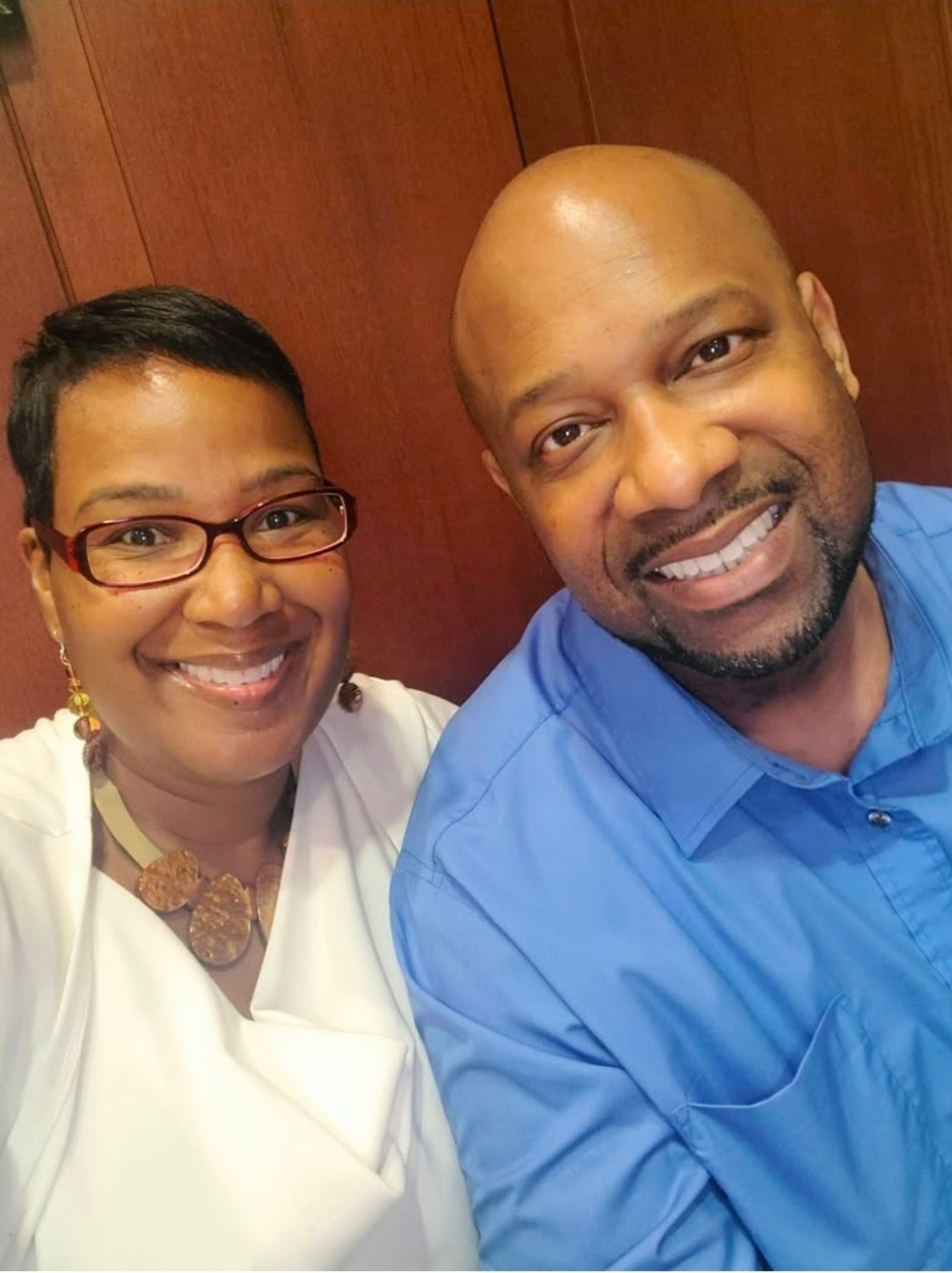 A selfie of a husband and wife smiling together.