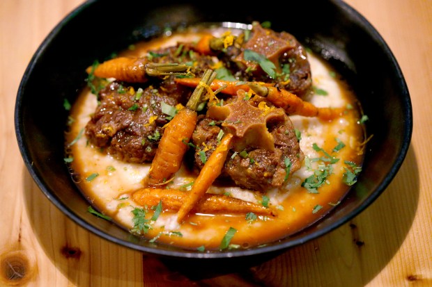 The oxtail and grits with carrots and orange gremolata is served at Top Hatters Kitchen & Bar in San Leandro, Calif., on Tuesday, Jan. 21, 2020. The popular neighborhood restaurant is owned by the husband-and-wife team of DanVy Vu and Matthew Beavers. (Jane Tyska/Bay Area News Group)