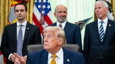 Getty Images Michael Kratsios, director of the White House Office of Science and Technology Policy, from left, US President Donald Trump, Howard Lutnick, US commerce secretary, and Chris Wright, US energy secretary, during an executive order signing in the Oval Office of the White House in Washington, DC, US, on Monday, June 22, 2026.