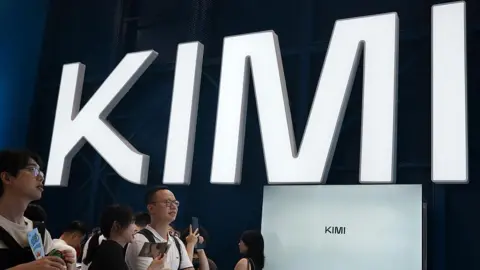 Future Publishing via Getty Images Visitors at a trade show in Shanghai visit a booth with the Kimi sign displayed in large block letters