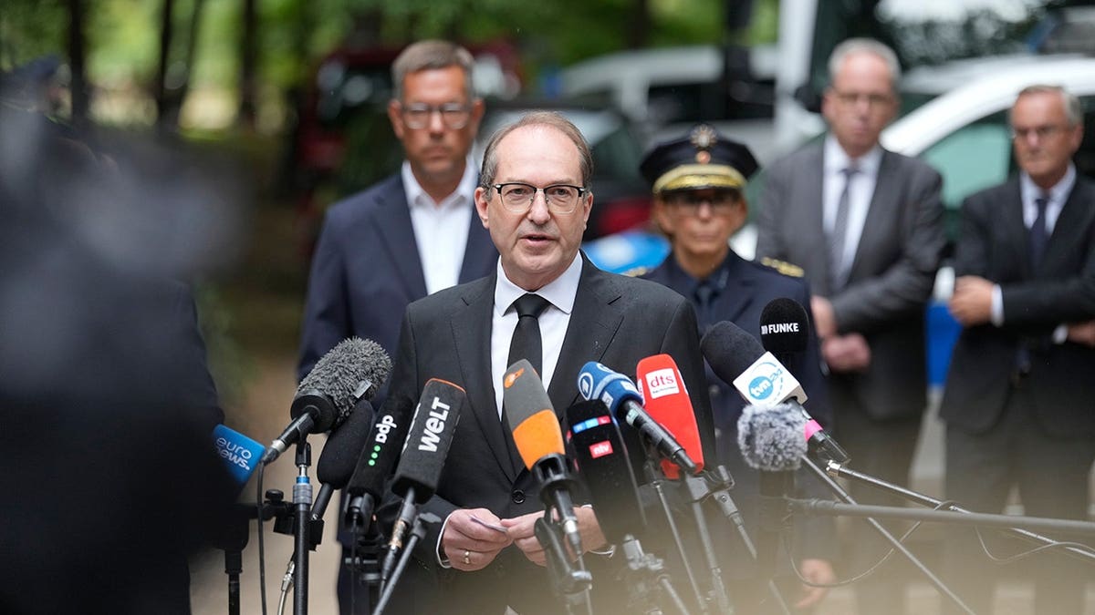 Alexander Dobrindt speaks to reporters near the scene of a car incident at Berlin Pride March.