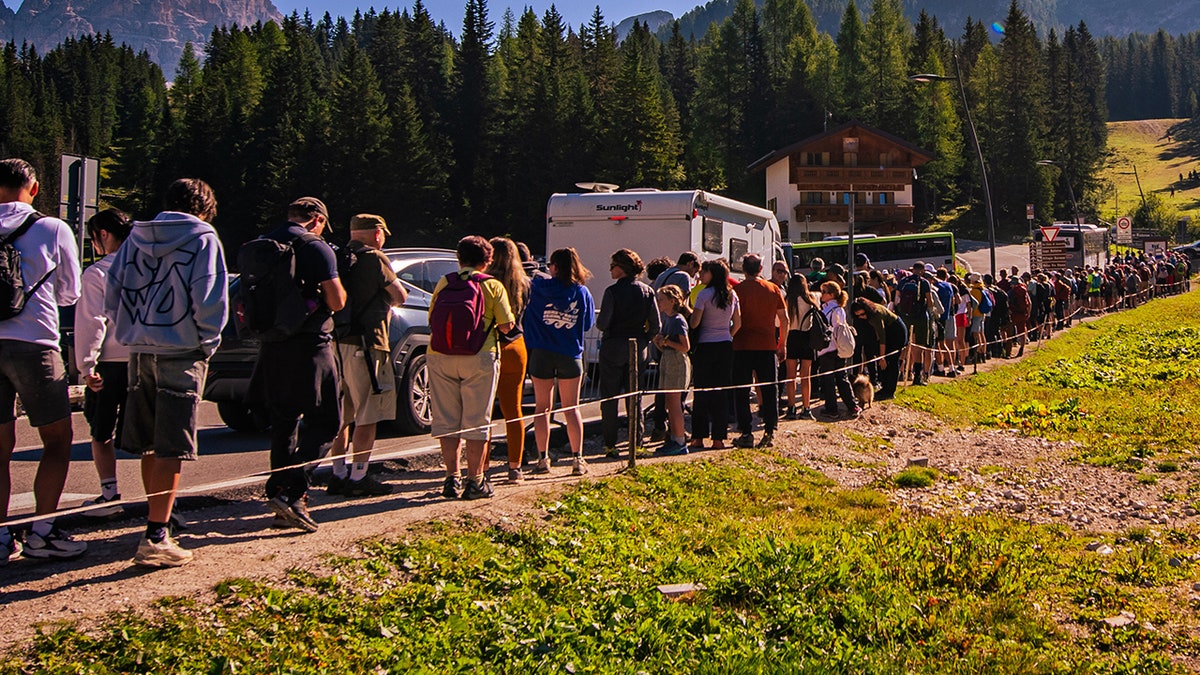 Tourists queue to take the shuttle bus to the Tre Cime di Lavaredo