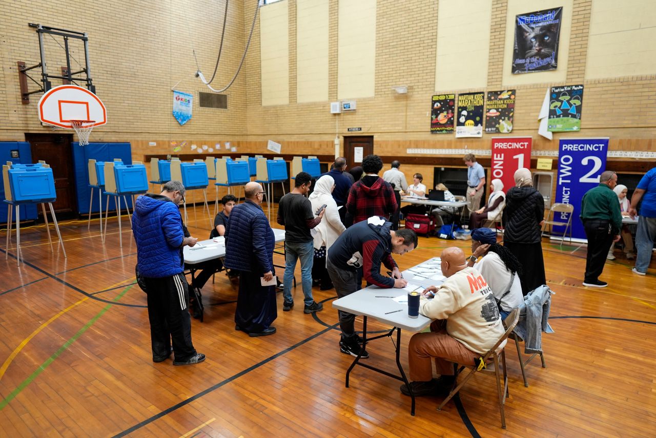 Voters wait to receive their ballots at a polling place at McDonald Elementary School, on November 5, 2024, in Dearborn, Michigan.