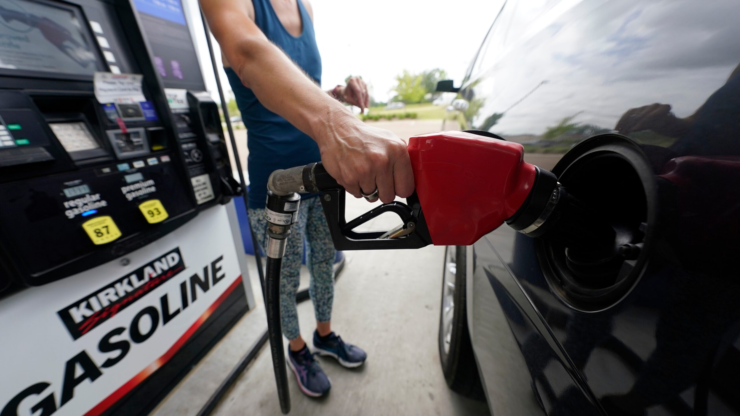 A person pumping gas.