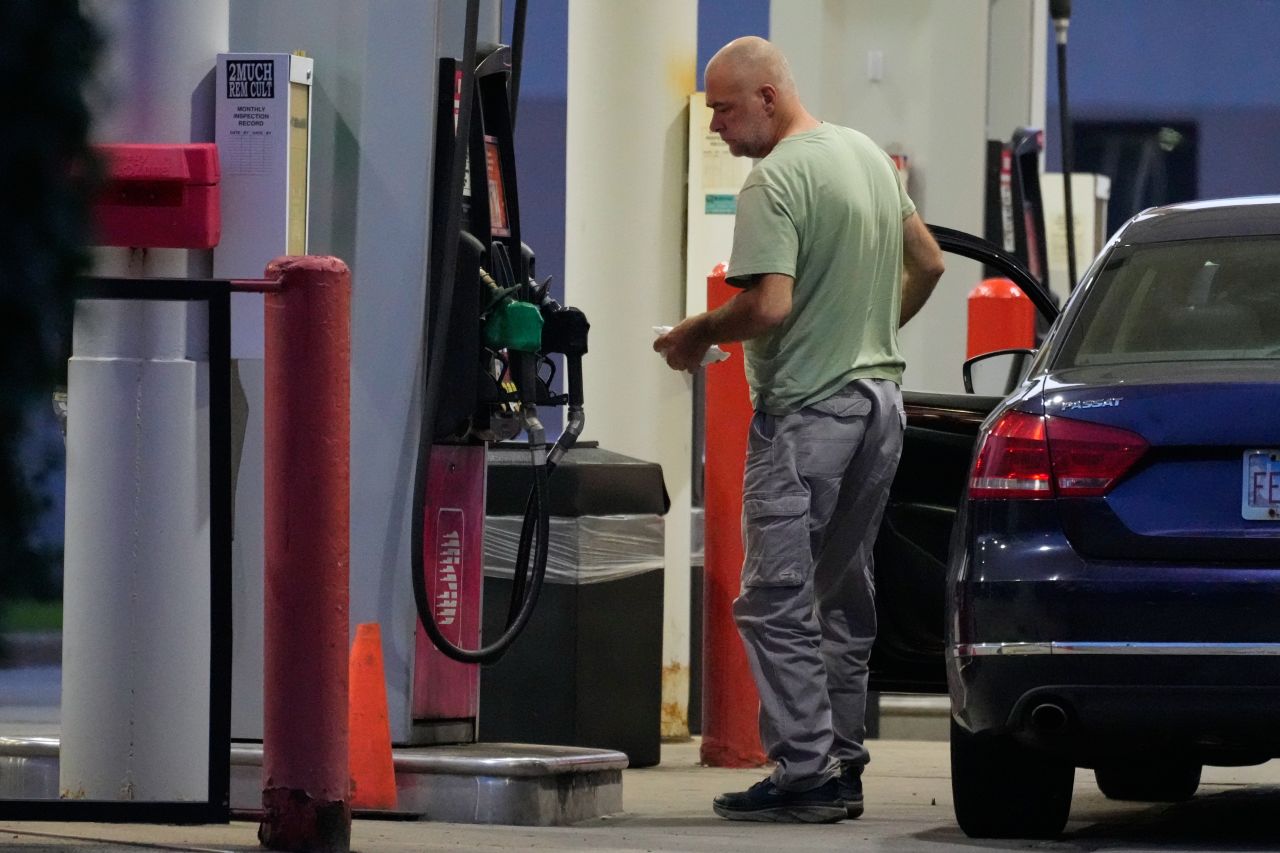 A customer checks on gas price at a gas station in Buffalo Grove, on June 25.