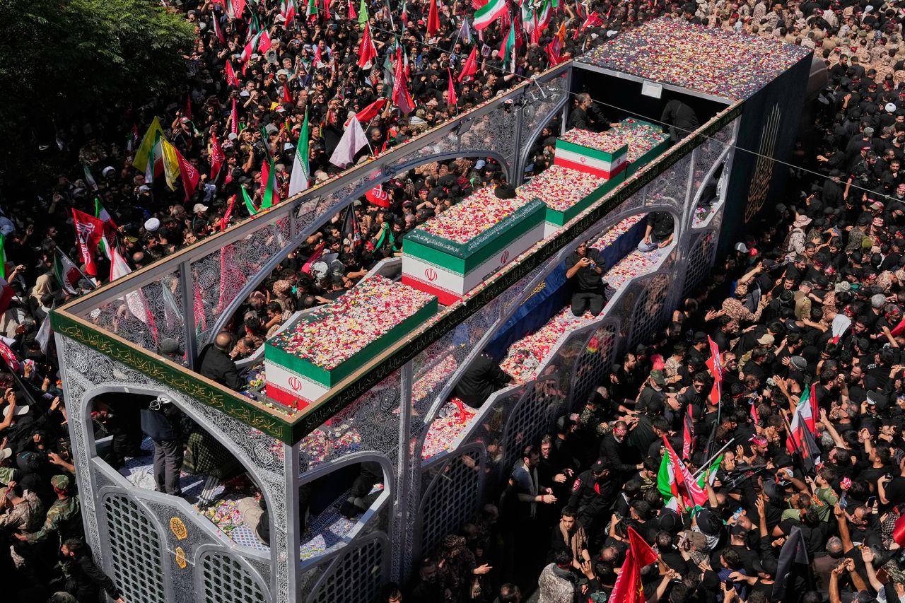 Mourners surround a truck carrying the coffins of the slain Iranian Supreme Leader Ayatollah Ali Khamenei and members of his family during a funeral procession in Tehran, Iran, on July 6.