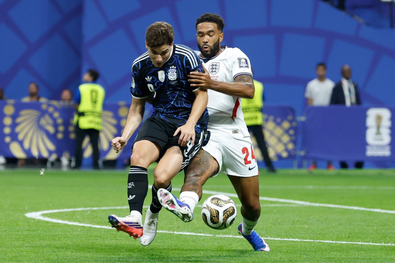 Argentina's Julián Alvarez, left, and England's Reece James compete for the ball.