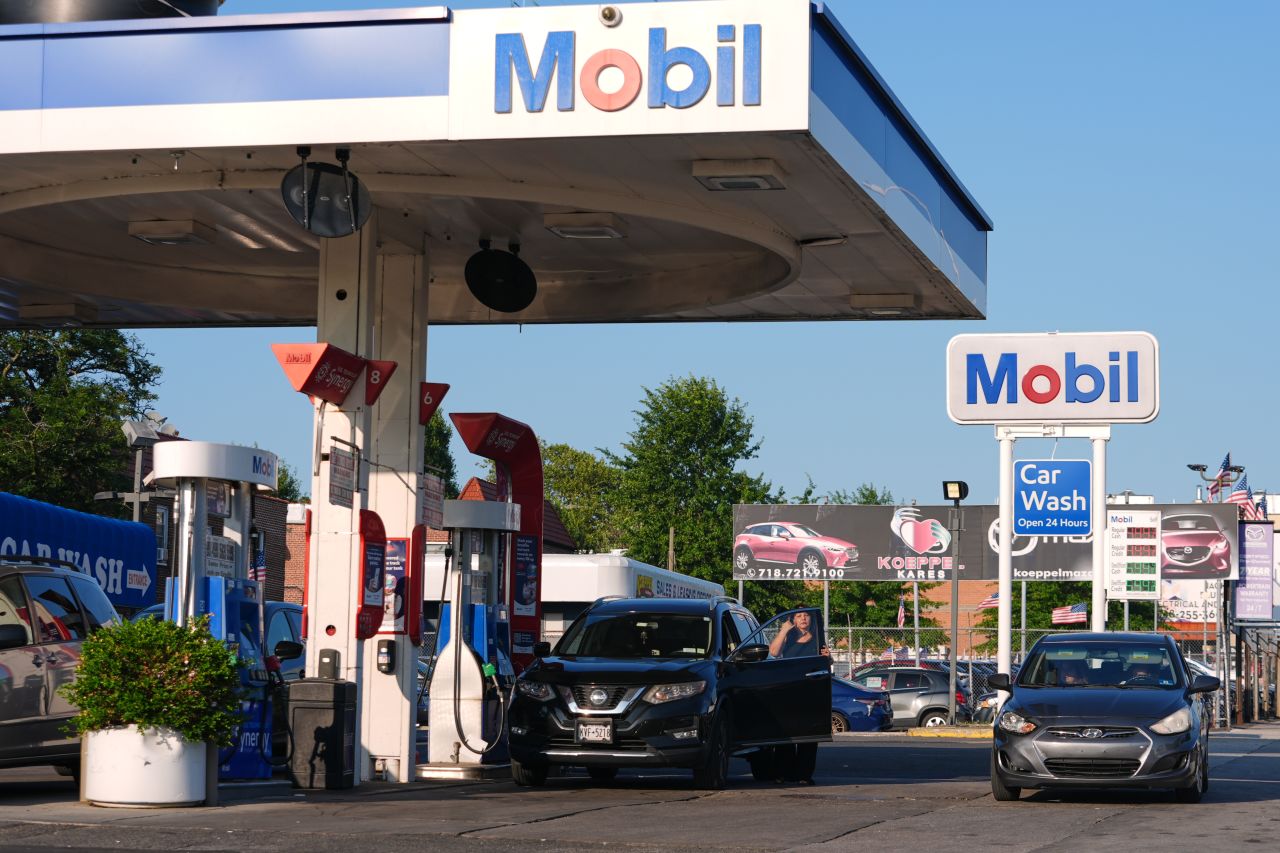 Cars navigate a Mobil gas station in the Queens borough of New York on Thursday.
