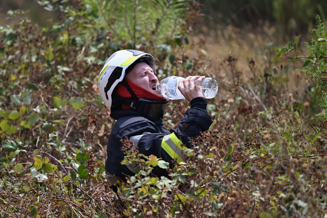 A firefighter takes a drink of water while battling a wildfire outside Bordeaux, France.