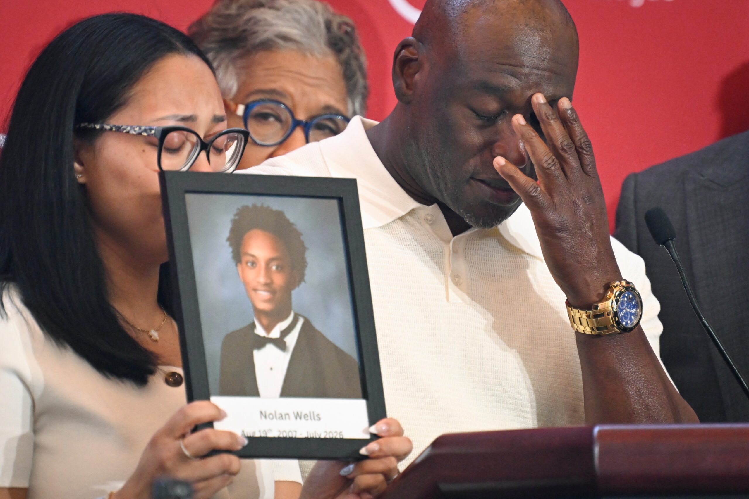 Elmore Wonsley, right, pauses from speaking as wife Christine Wonsley holds a photo of her deceased son, Nolan Wells, as they appear at the National Urban League's annual conference, Thursday, July 30, 2026, in Nashville, Tenn.