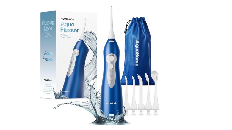 The Aquasonic Aqua Flosser water flosser, its box, and its accessories against a white background.