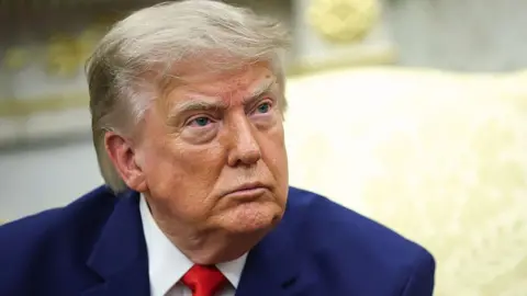 Getty Images President Donald Trump listens to a reporter's question in the Oval Office of the White House on July 21, 2026 in Washington, DC.