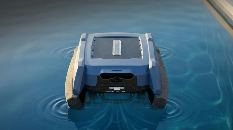 The Betta Neo solar-powered robotic pool skimmer on the surface of a swimming pool.