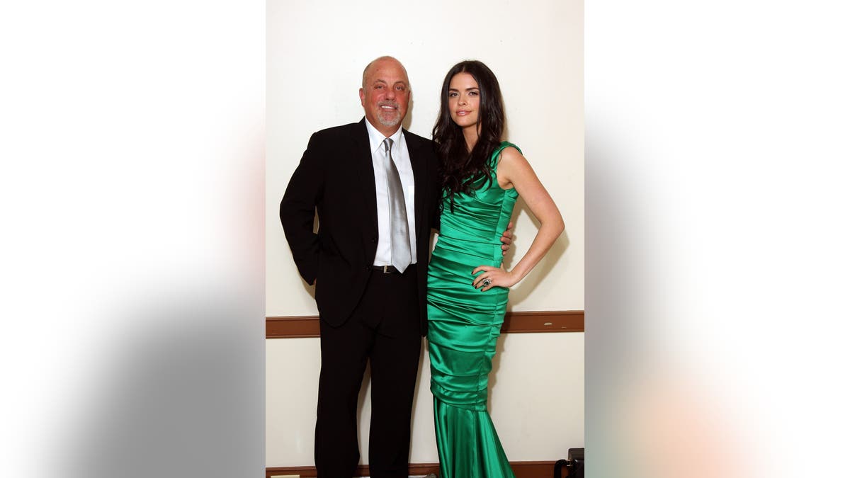 Billy Joel and Katie Lee Joel stand backstage together after a performance