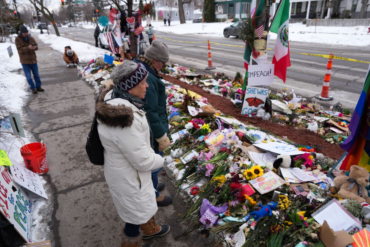 People stop at a memorial for Renee Good in Minneapolis, Minnesota, on February 4, 2026.