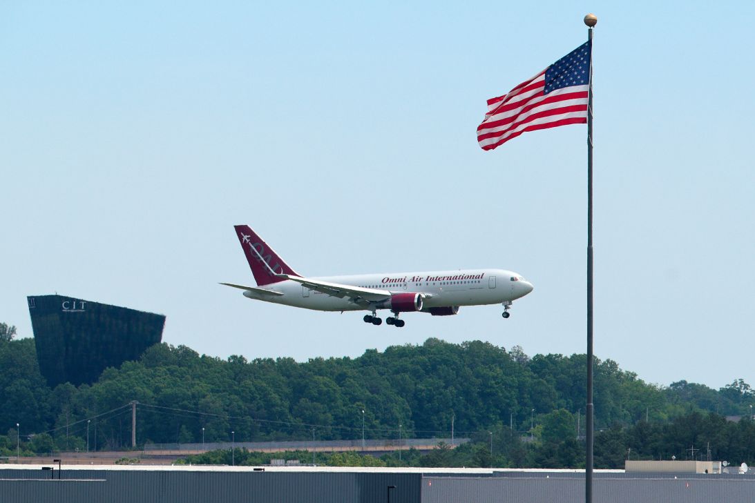 An Omni Air International charter flight from South Africa to the United States lands at Washington Dulles International Airport on May 12, 2025 in Dulles, Virginia. Several dozen white South Africans, also called Afrikaners, accepted an invitation from the Trump Administration to come to the United States as refugees.
