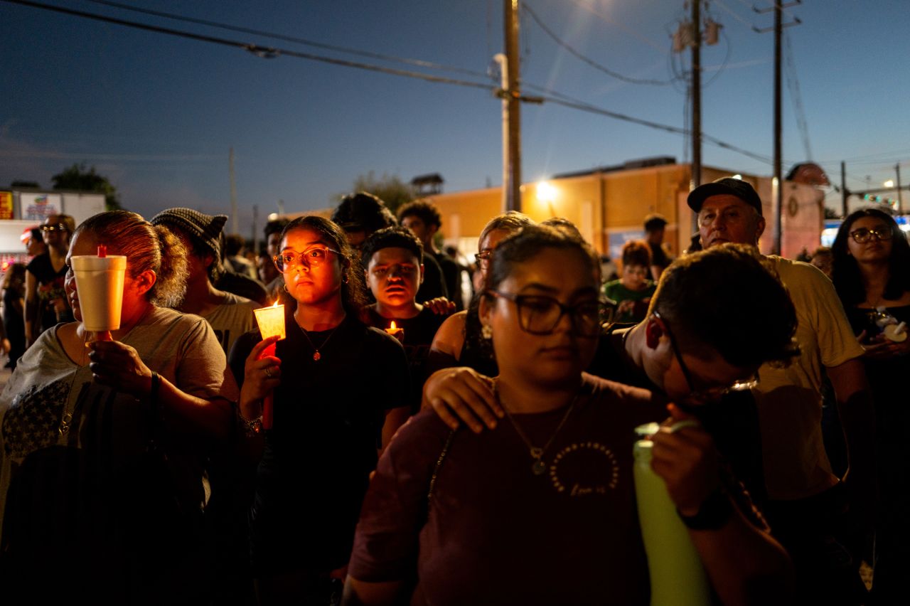 People pay their respects for Mexican immigrant Lorenzo Salgado Araujo during a candlelight vigil on July 8, in Houston.