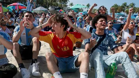 Joe Raedle/Getty Images People react as Argentina plays against Spain during a FIFA World Cup match watch party on July 19, 2026 in Miami Beach, Florida. Argentina and England