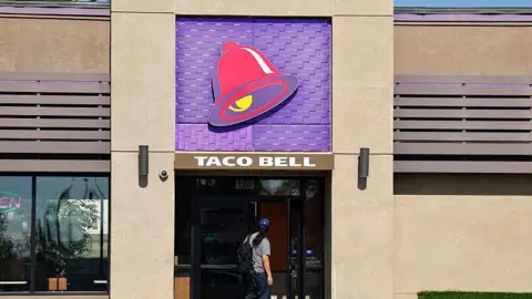 Getty Images A person enters a Taco Bell restaurant on July 14, 2026 in Pasadena, California.