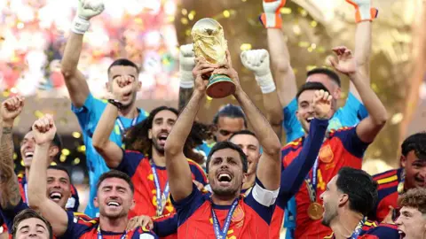 Getty Images Rodri, captain of Spain lifts the FIFA World Cup Winner’s Trophy after the team’s victory following the final match between Spain and Argentina at New York New Jersey Stadium.