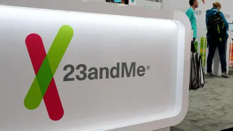 Reuters A kiosk with the 23andMe logo on it, sitting in a lobby with people standing nearby.