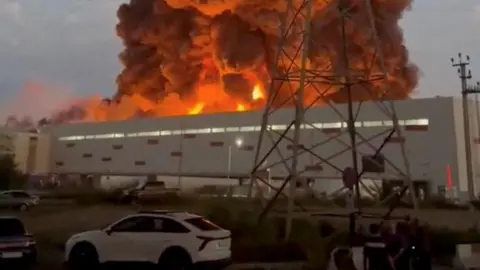 Reuters Smoke rises from a Wildberries warehouse on fire after an attack in Nevinnomyssk, Russia, July 22, 2026