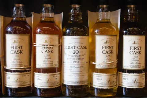 Bloomberg via Getty Images Bottles of first cask malt Scotch whisky inside a whisky shop in Aberdeen, Scotland.