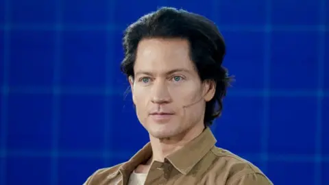 Getty Images Bryan Johnson pictured in 2021 - he has swept-back dark hair, blue eyes and is wearing a pale brown shacket.