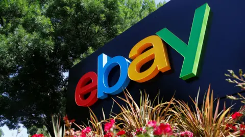 Reuters eBay's primary colored company logo at the entrance of an office building.