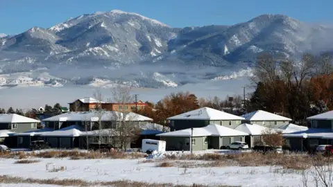 Getty Images A new housing development sits at the base of a snowy mountain range