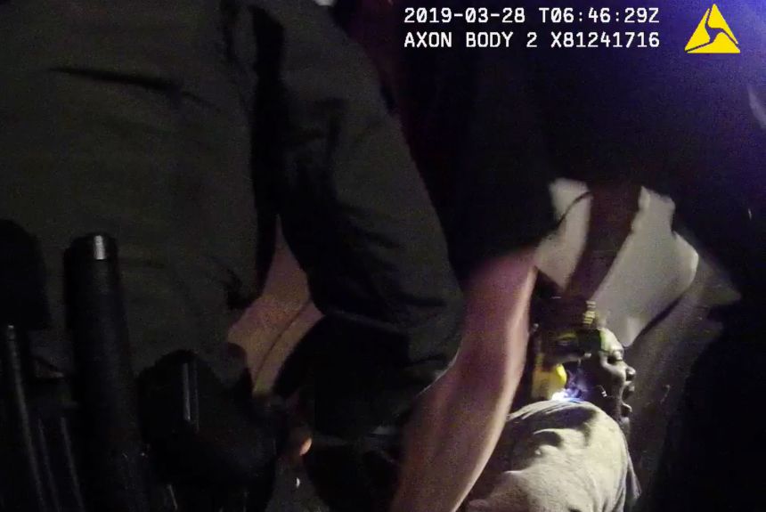 In this image from a March 28, 2019, body-worn camera video provided by the Austin Police Department in Texas, Williamson County deputies hold down Javier Ambler as one of them uses a Taser on Ambler's back during his arrest. 