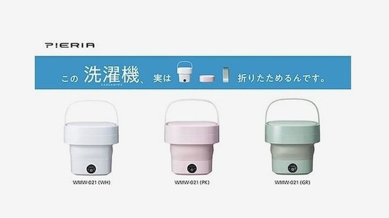 Different colors of folding washing machines in a line on a white background
