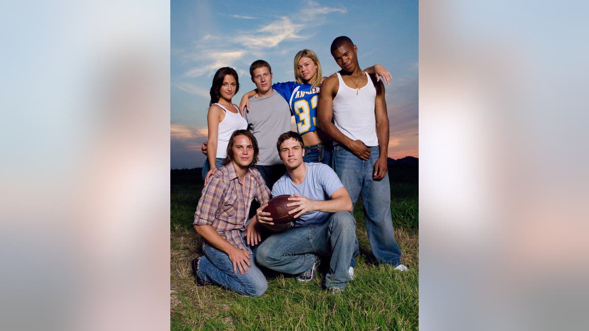 Minka Kelly, Zach Gilford, Adrianne Palicki, Gaius Charles, Scott Porter and Taylor Kitsch pose in two rows.