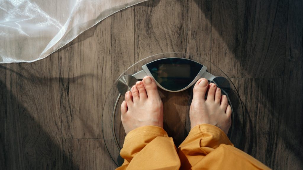 A person standing on scales.