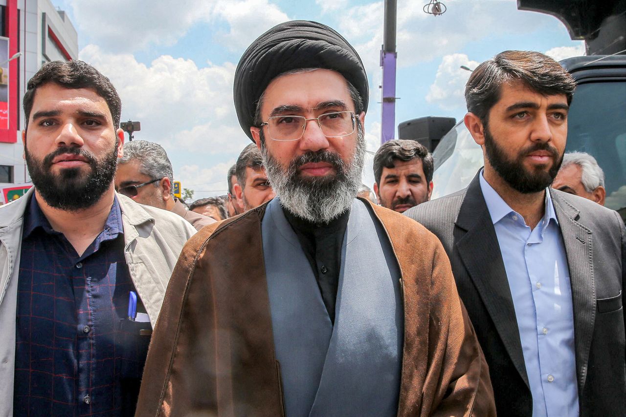Iran's supreme leader Mojtaba Khamenei, center, walks along a street in Tehran on May 31, 2019.