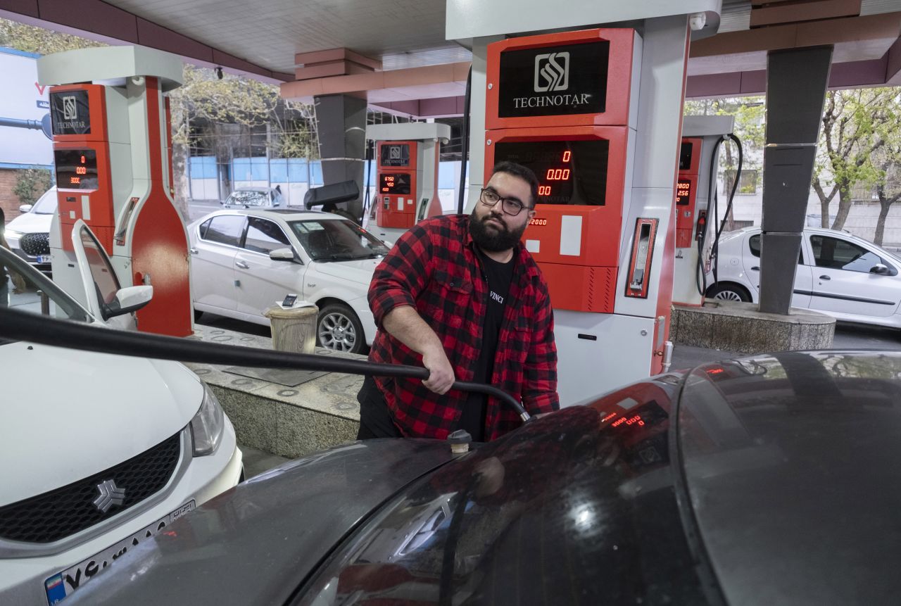 A man pumps fuel into his vehicle at a petrol station in Tehran, Iran, on March 26.