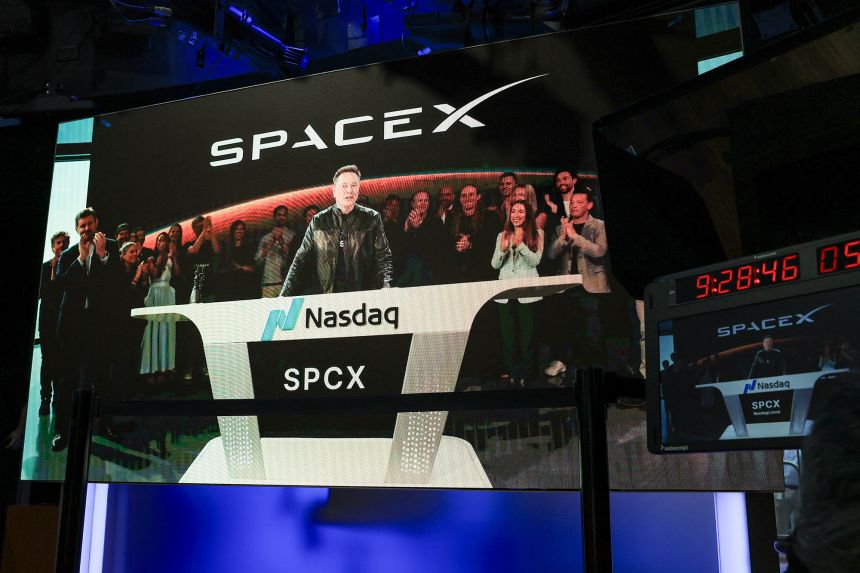 SpaceX CEO Elon Musk, displayed on a screen remotely from SpaceX headquarters in Starbase, Texas, speaks before the launch of SpaceX's initial public offering at the Nasdaq MarketSite in New York on June 12, 2026.