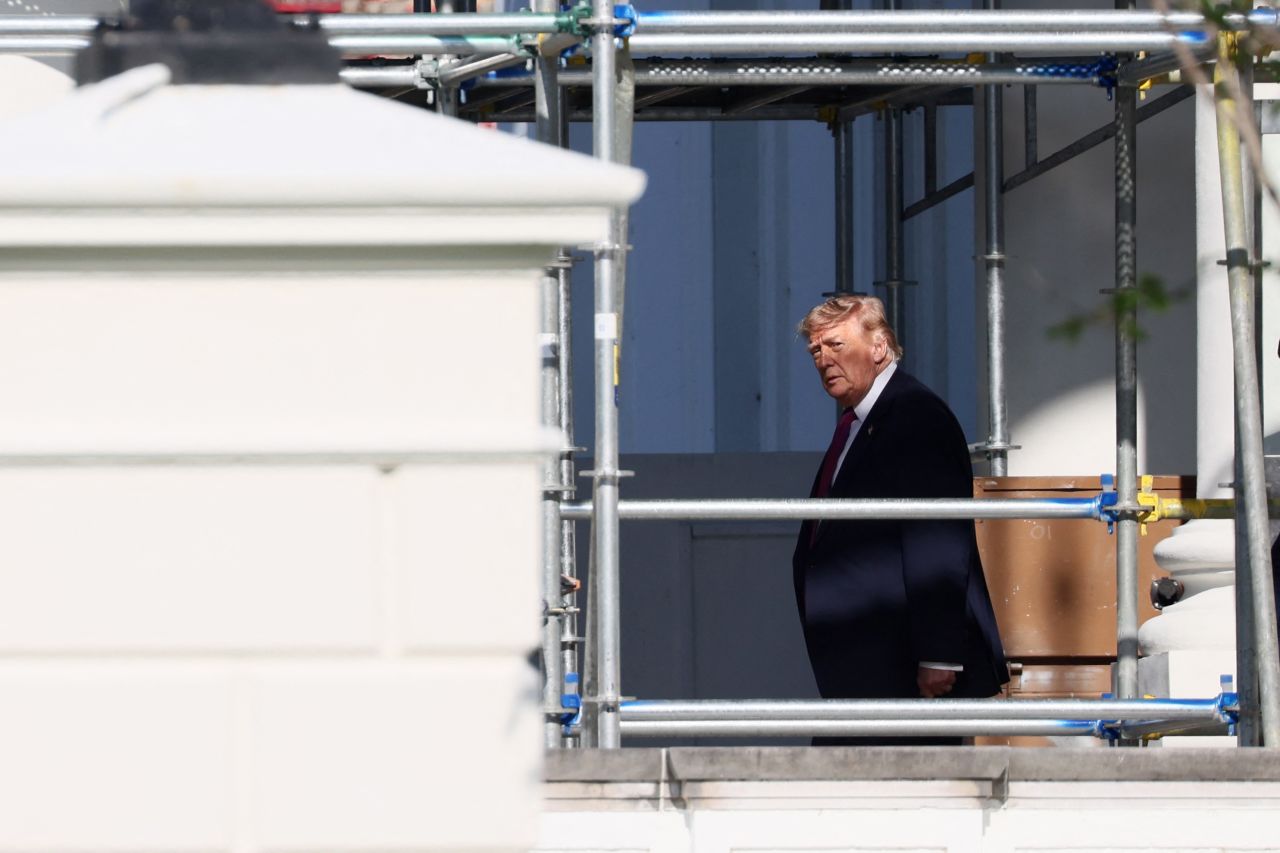 US President Donald Trump walks beneath scaffolding as he departs the White House on July 3.