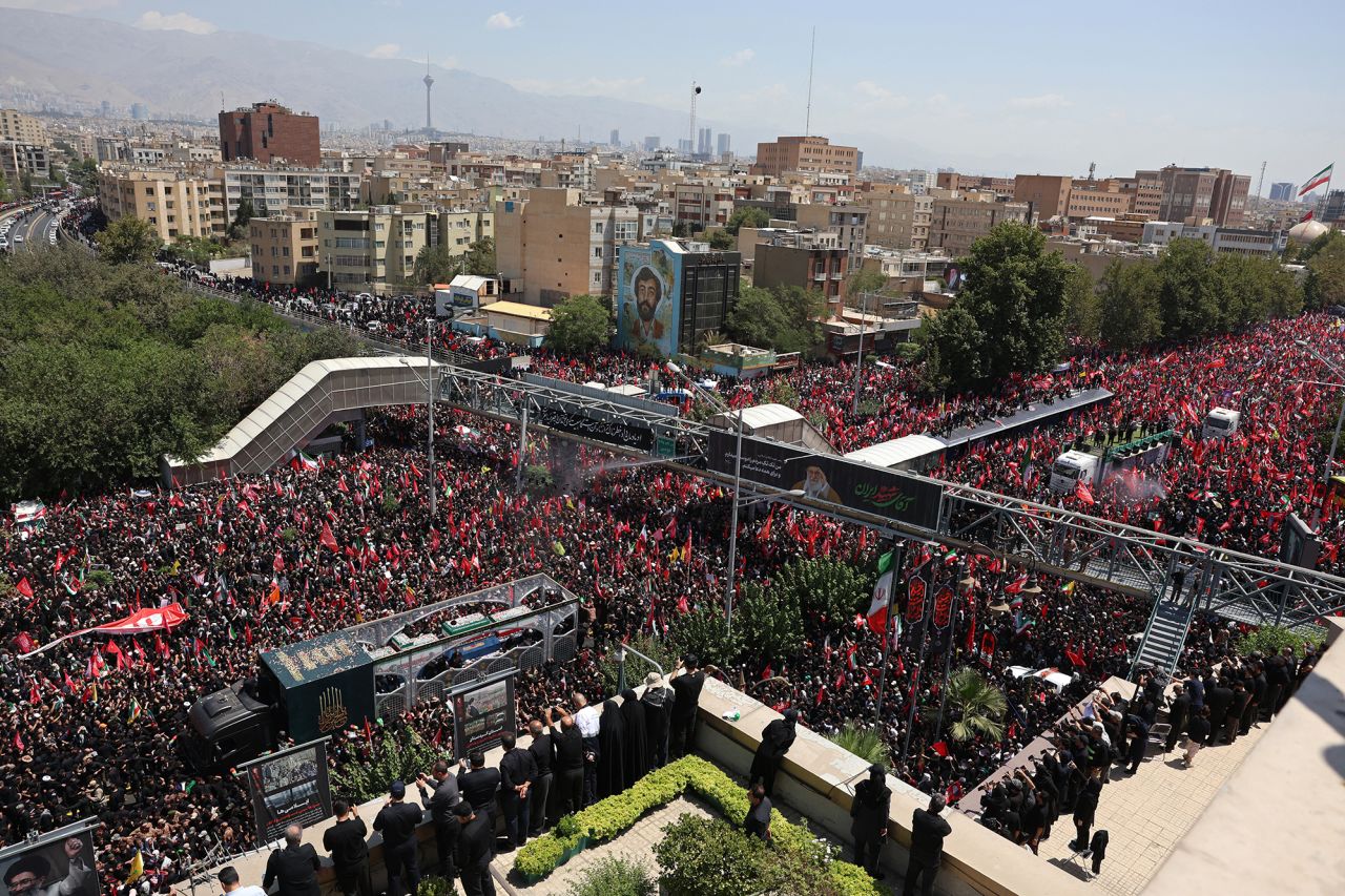 People gather along a street in Tehran during the funeral procession.