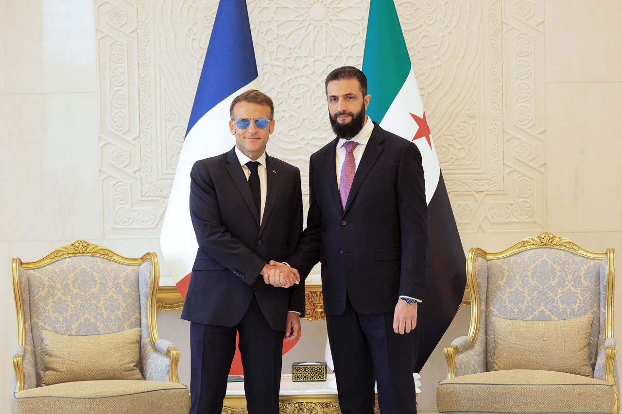France's President Emmanuel Macron, left, shakes hands with Syrian President Ahmed al-Sharaa ahead of their meeting at the People's Palace in Damascus on Tuesday.