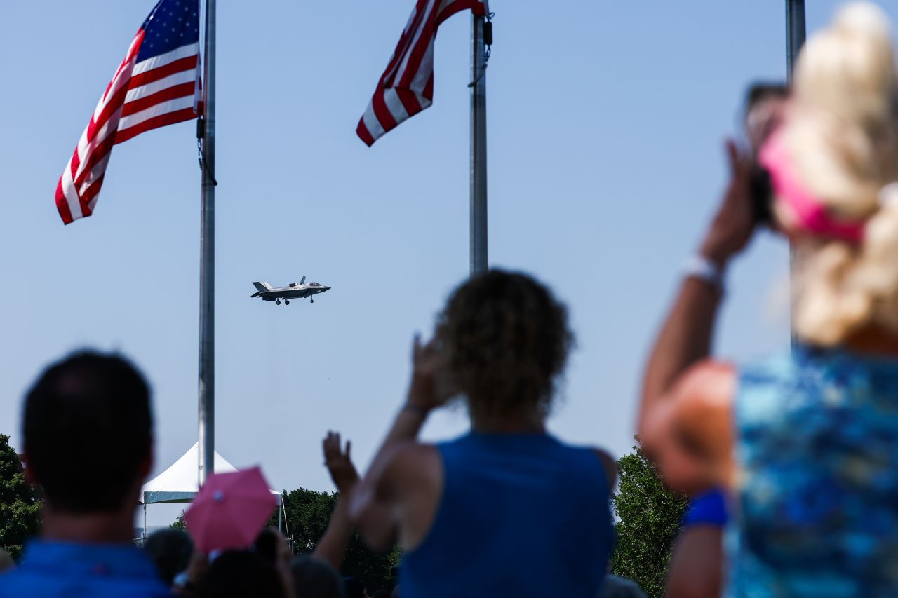 People watch as an F-35B demonstrates hovering capability near the Washington Monument during pre-Fourth of July festivities on the National Mall in Washington DC, on July 3.